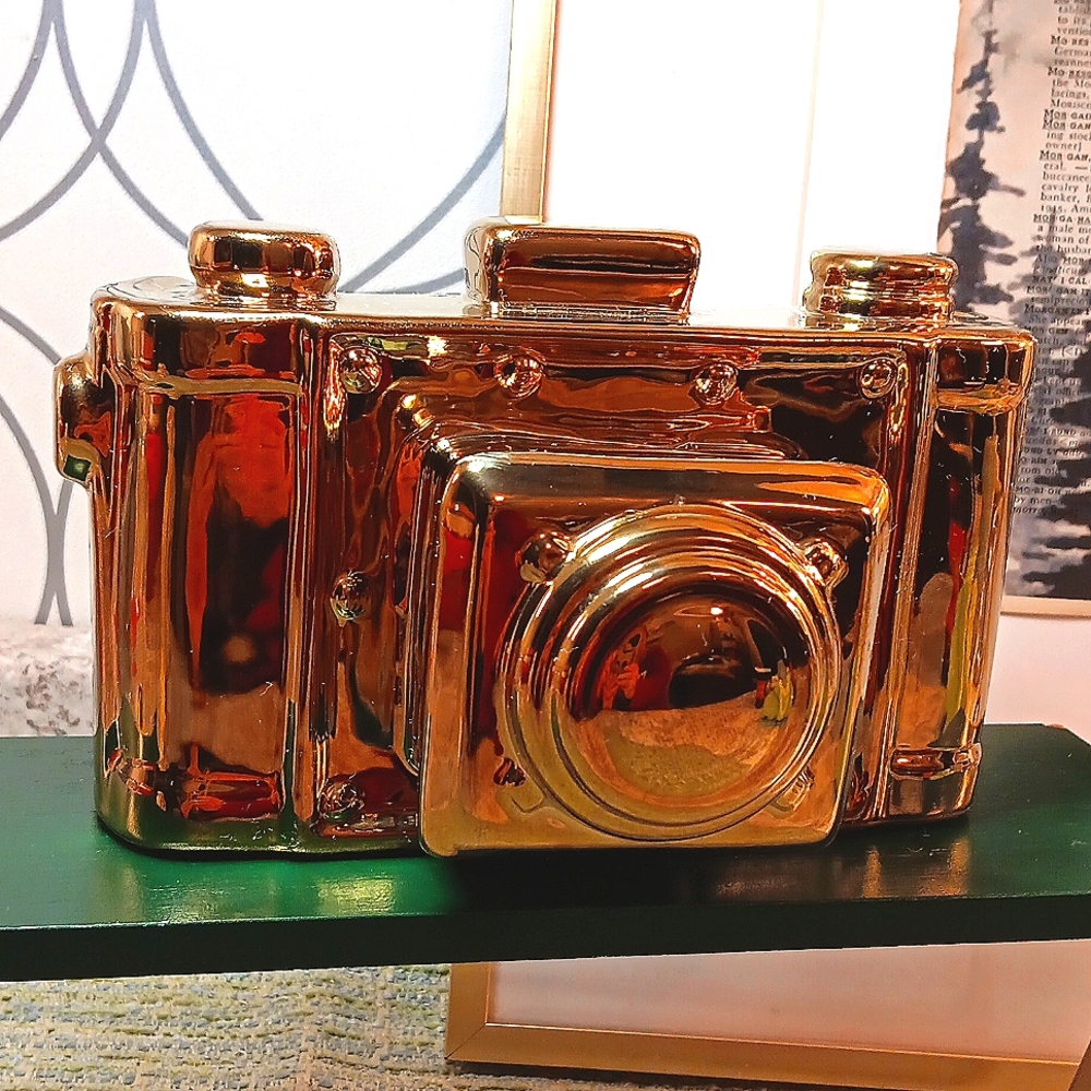 Yellow metal ceramic camera for unique decor.